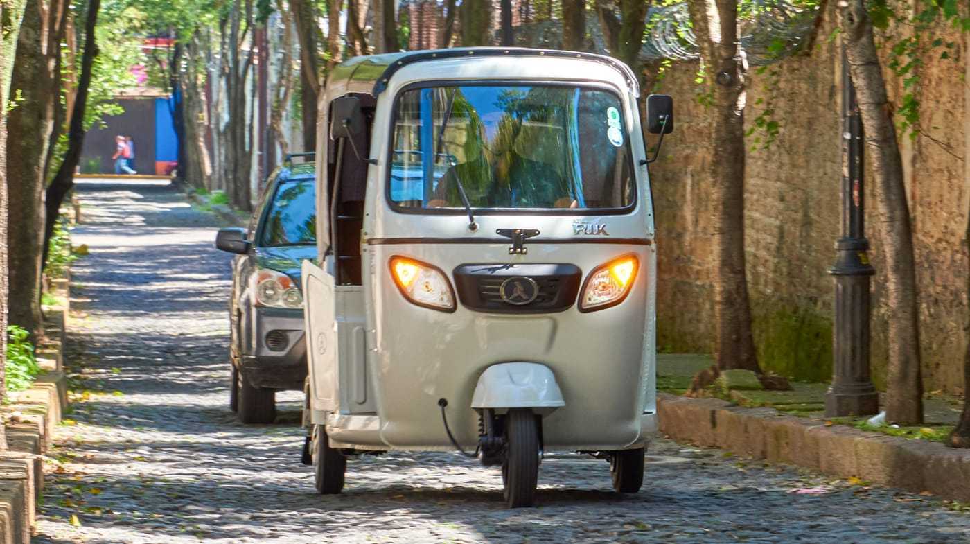 Atul three-wheeler on a cobblestone street in Colombia
